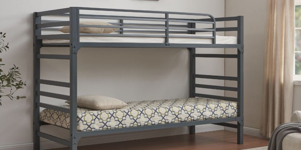 A bunk bed with a chair, ideal for maximizing space. Astoria Bunk Bed: strong metal frame, safety barriers, compact design for shelter residents.