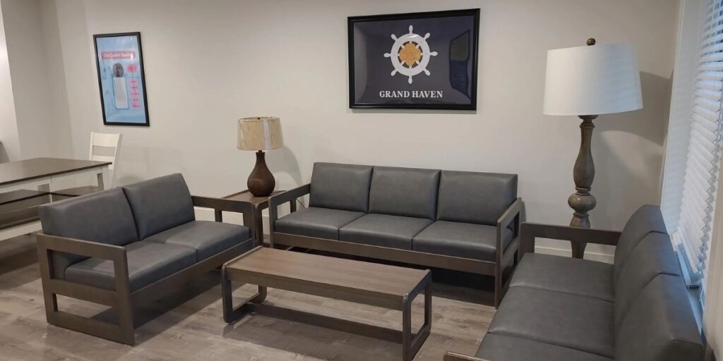A living room with couches and a table. Bariatric chairs with adjustable armrests, reinforced frames, and anti-microbial materials.