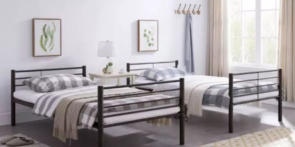 Two twin beds adorned with pillows and blankets, showcasing design flexibility for healthcare room functionality.