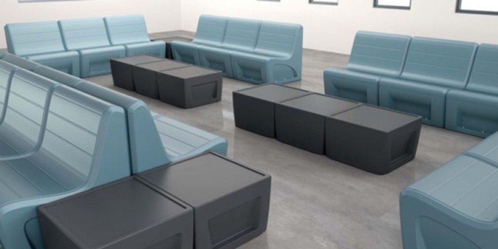 A spacious room featuring blue seating and black cubes, suitable for both indoor and outdoor therapeutic activities.