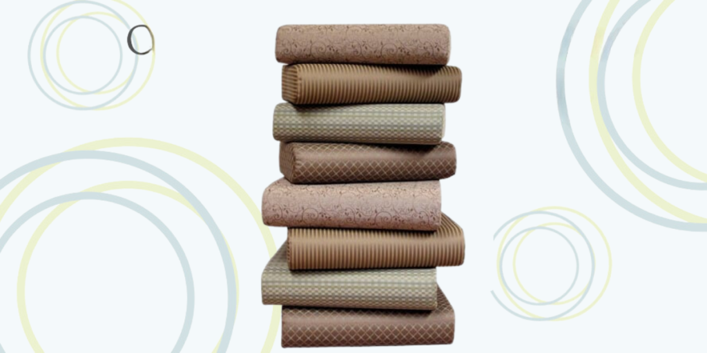 A stack of toilet paper rolls neatly arranged on a clean white background, emphasizing simplicity and utility.