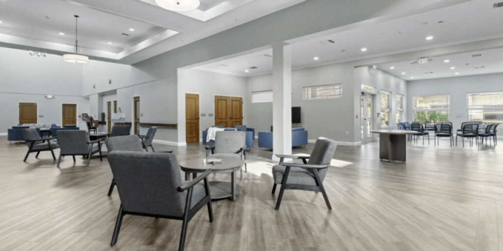 Dining room in a senior living community featuring specialized furniture for comfort and accessibility.