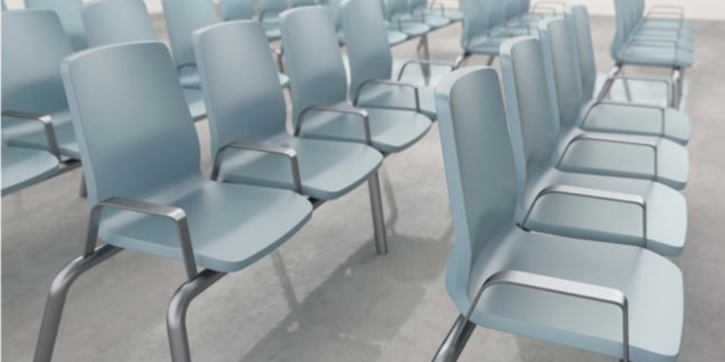 A row of chairs arranged neatly in a conference room, designed for meetings and collaborative discussions.