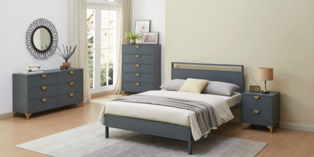A cozy bedroom featuring a bed, dresser, and nightstand, designed for comfort and functionality.