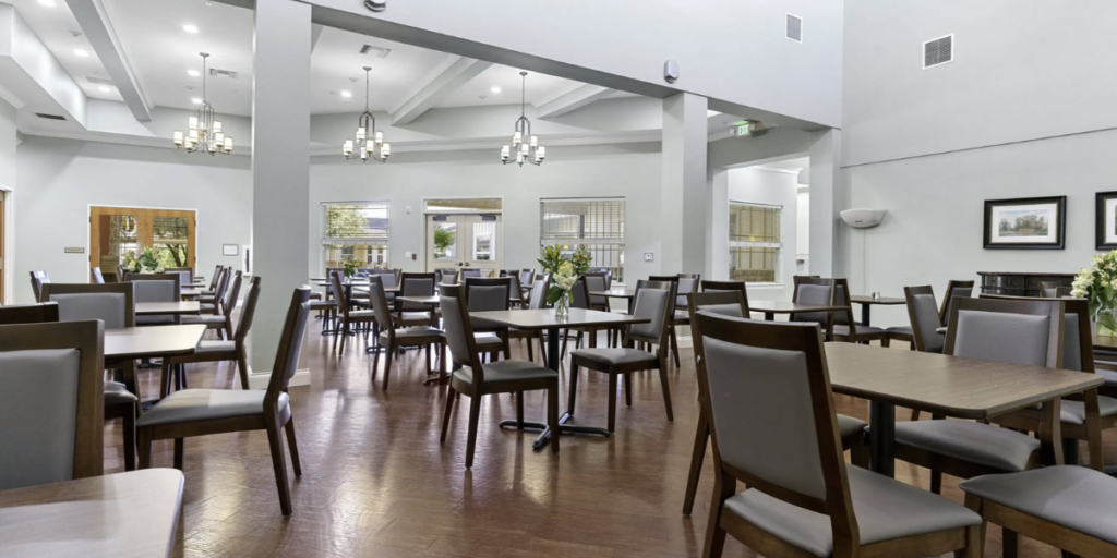 Dining room in a senior living community, featuring comfortable seating and a welcoming atmosphere for residents.