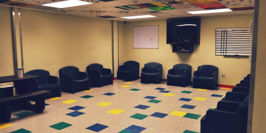 A functional room featuring stackable chairs and a foldable table, designed for versatile communal use and efficient space management.