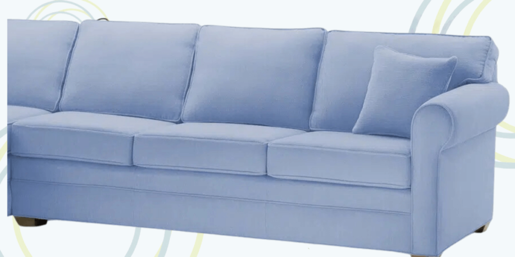 A blue sectional couch with a wooden base, designed for durability and flexibility in various room layouts.