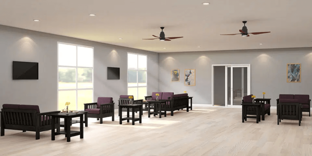 A spacious room featuring a ceiling fan and several chairs arranged for comfort and functionality.

