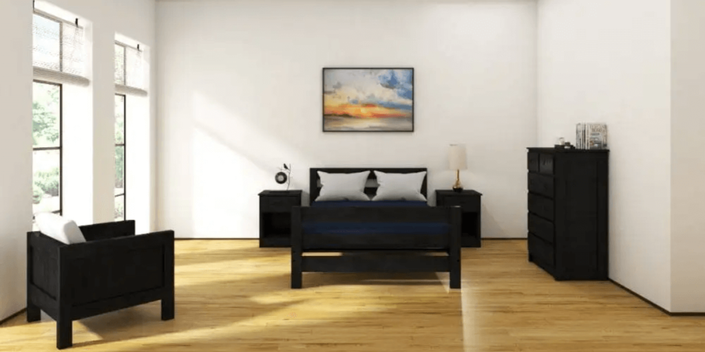 A cozy bedroom featuring a bed, dresser, and chair, showcasing practical furniture for group homes and human services programs.