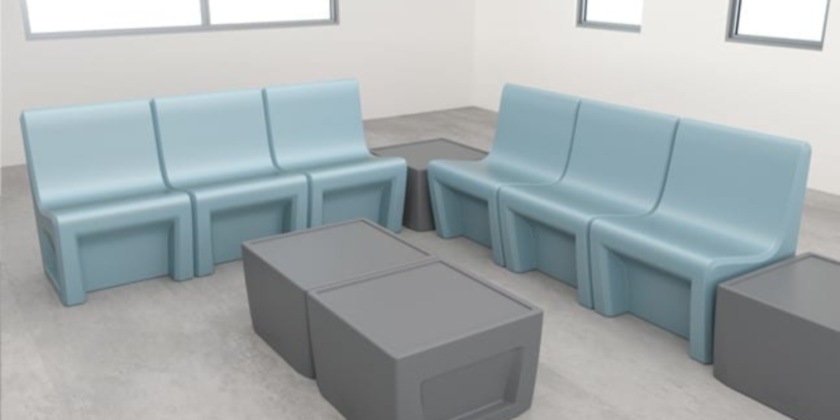 Blue and grey seating area with a table, designed for flexible use in contemporary medical environments.