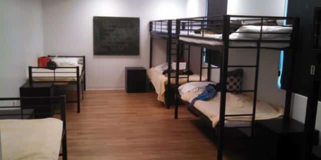 Bunk beds in a room, featuring full-length guardrails, sturdy ladders, and rounded edges for safety and usability.