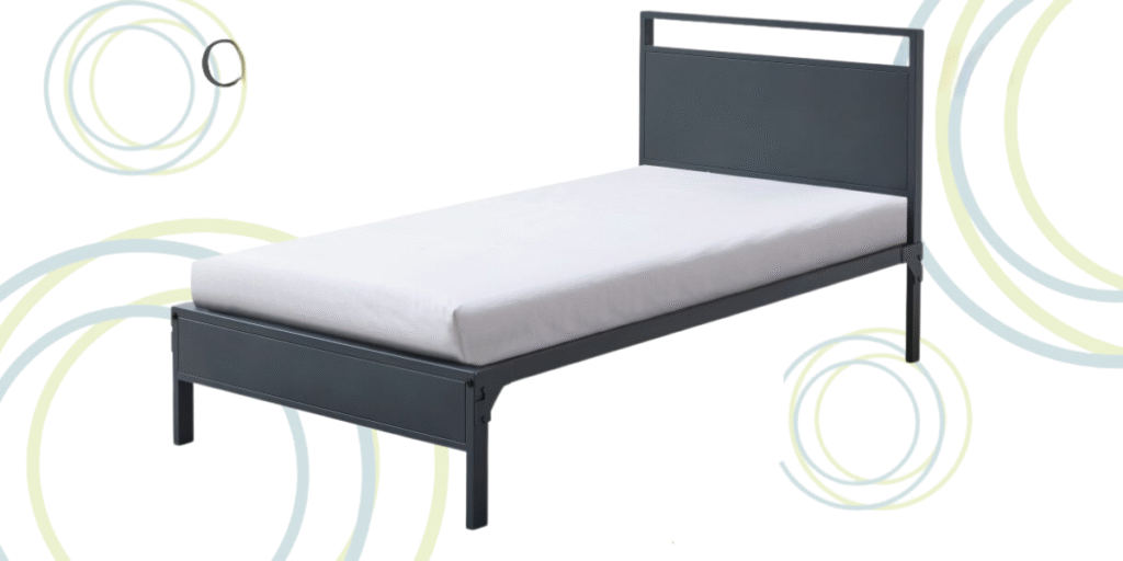 A metal bed frame with a white sheet neatly arranged on it, highlighting its strength and reliability for various facilities.