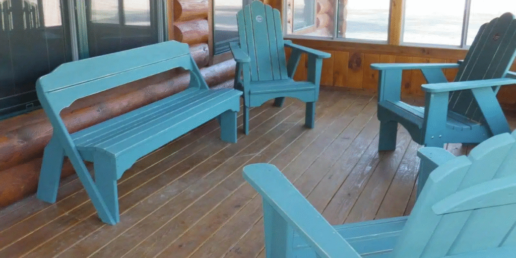 A porch featuring blue chairs and a window, creating a welcoming outdoor space for relaxation and connection.
