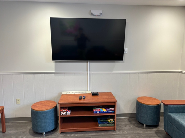 Shared television and activity area in the recovery home